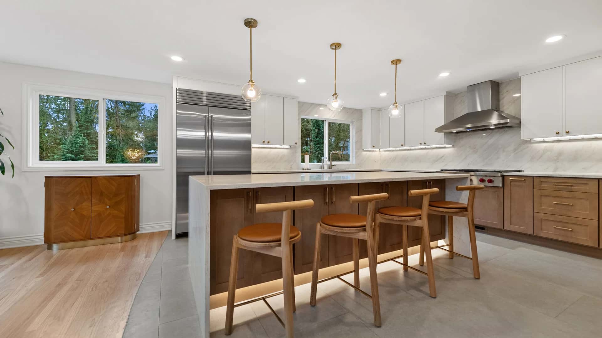 Modern kitchen with slab backsplash and integrated appliances in Kirkland, Washington