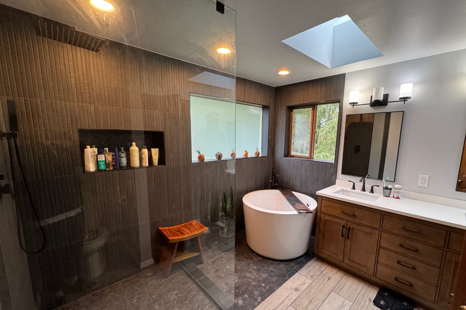 Homeowner reviewing a bathroom remodel plan with a professional remodeler in Seattle by Fine Element Construction