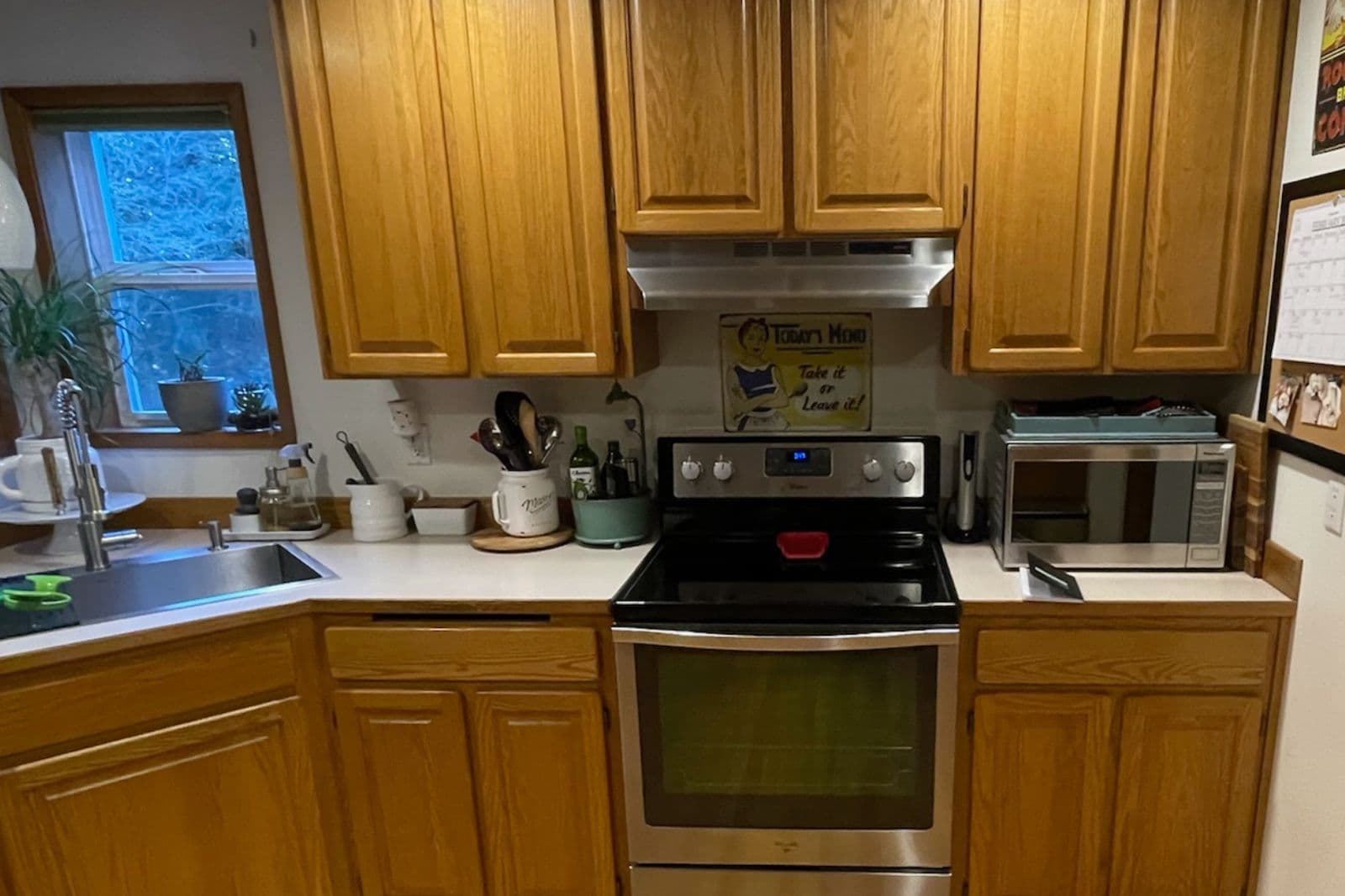 Modern Seattle kitchen remodel with cabinets going to the ceiling, stacked upper cabinets, warm wood details, and scribed trim by Fine Element Construction