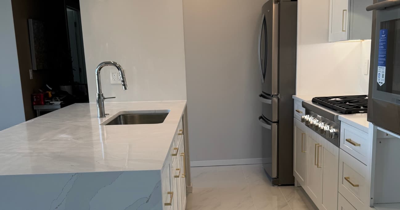Modern Pacific Northwest kitchen remodel in Seattle with warm wood cabinets, quartz countertops, large island, smart storage, layered lighting, and timeless 2026 design by Fine Element Construction