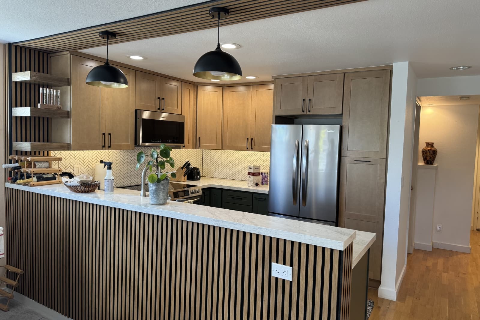 Modern kitchen remodel in Seattle with custom cabinets, quartz countertops, and updated lighting by Fine Element Construction