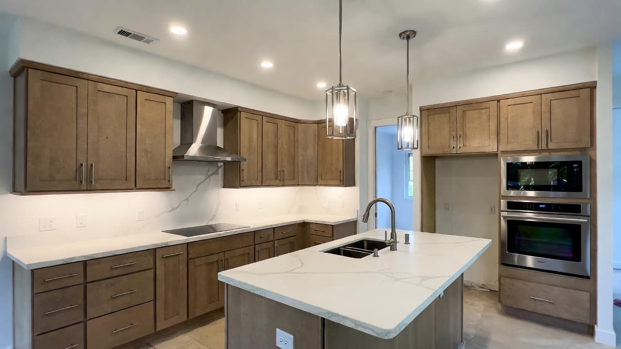 Modern full kitchen remodel in Kirkland with custom cabinets, quartz countertops, island, lighting, backsplash, and updated layout by Fine Element Construction